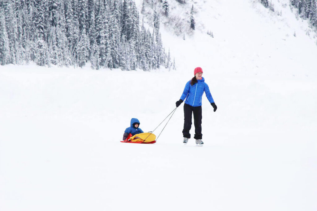 ice skating with baby in sled