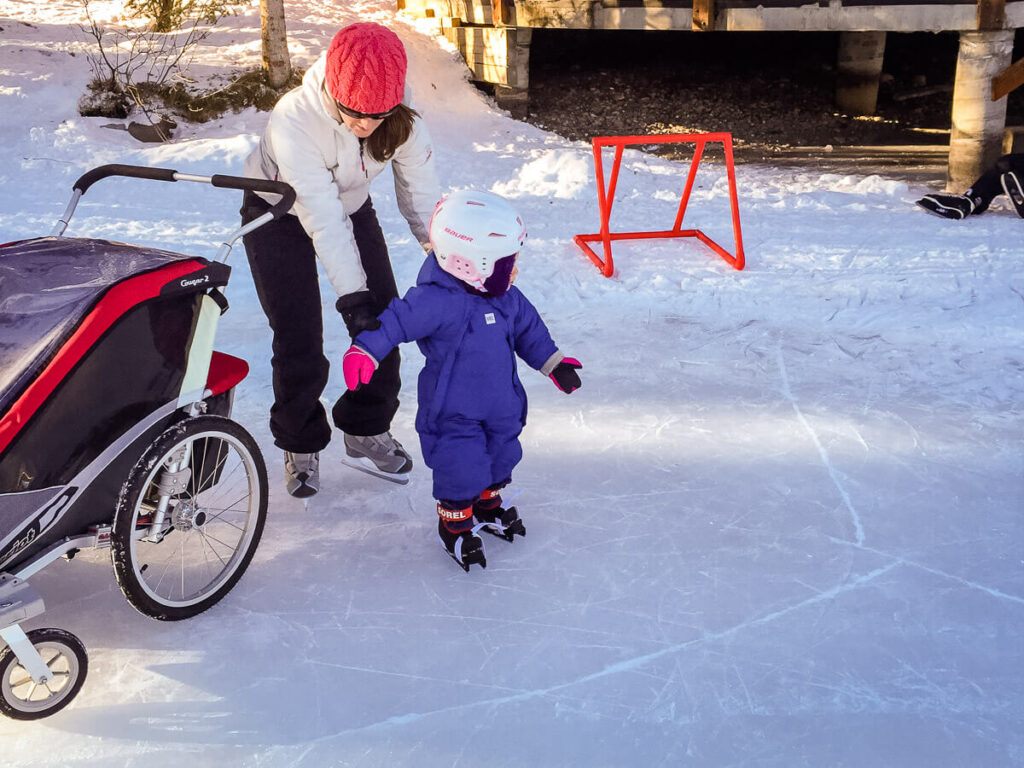 skating with a baby in a stroller is a fun winter activity with kids.