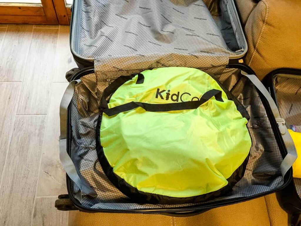 kidco peapod plus travel bed for toddlers folded in suitcase