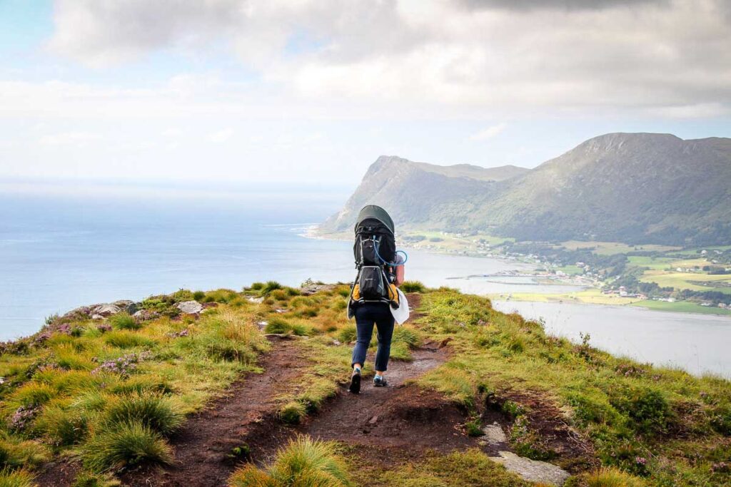 Celine Brewer, owner of BabyCanTravel.com, uses a backpack carrier for her toddler while hiking on a family vacation in Alesund, Norway.