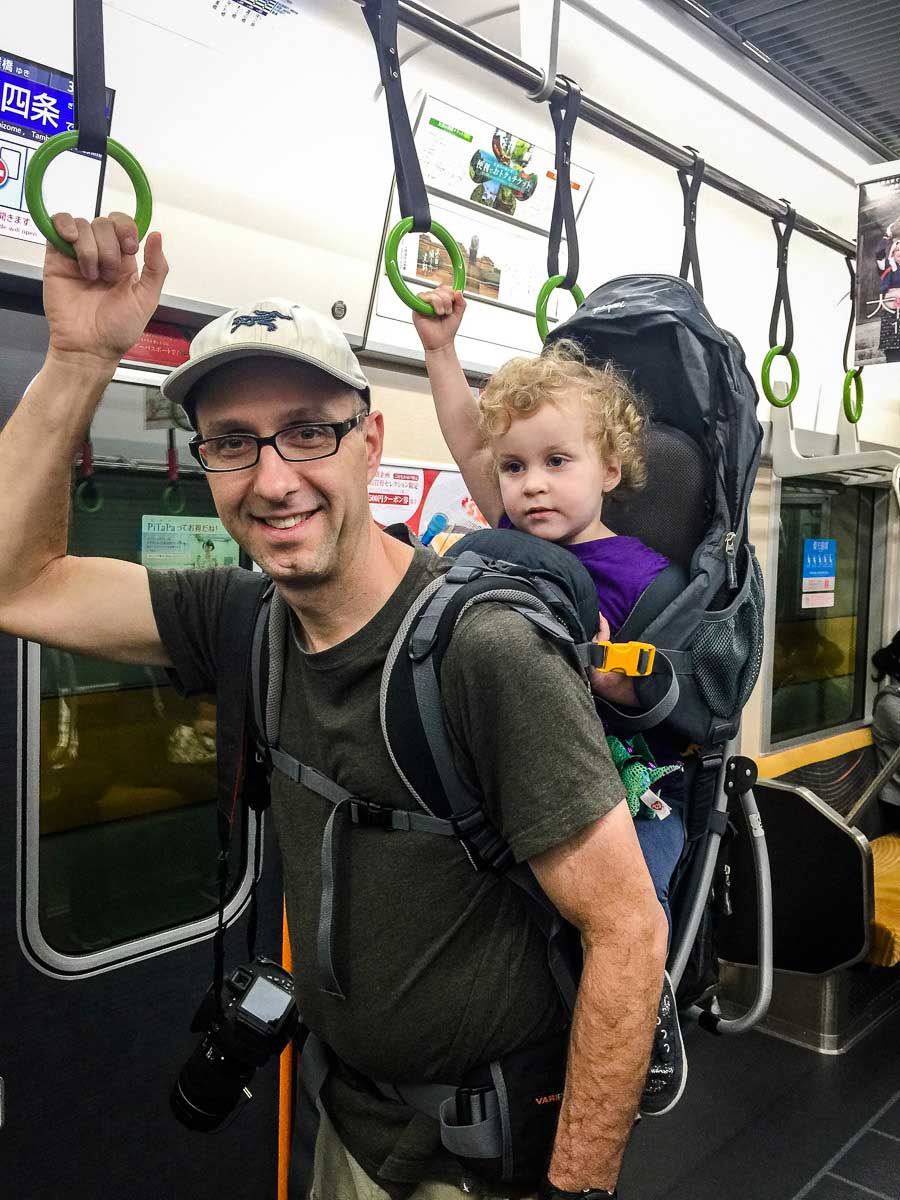 taking public transit with hiking backpack carrier for toddlers