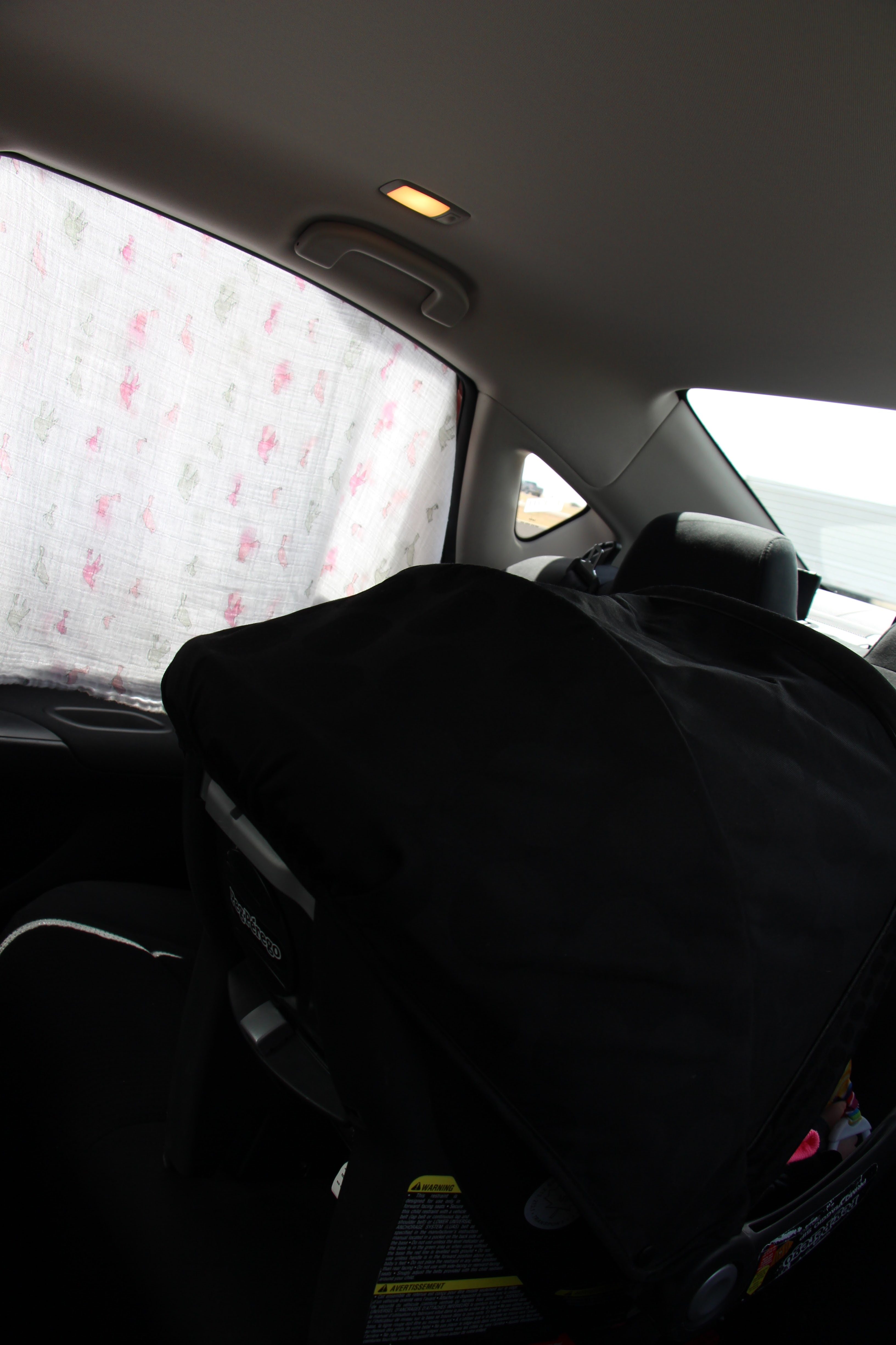 a creative use for an Aden & Anais Blanket is for a Shade Cover in a car.