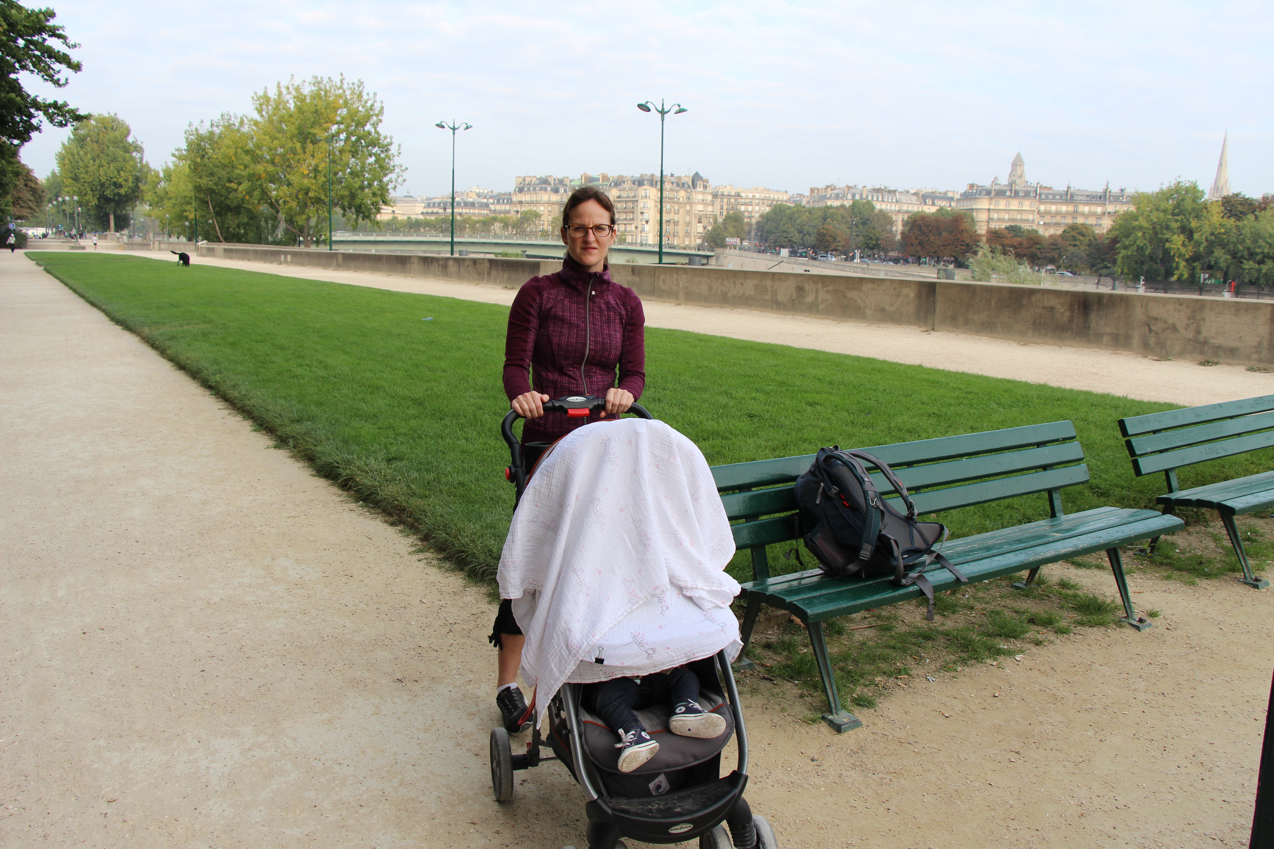 one of the many uses for an Aden & Anais swaddle blanket is a stroller cover for travel with baby