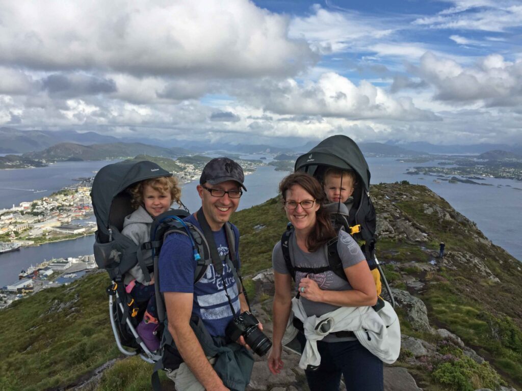 a mom and dad go hiking in norway with kids, with each child in a Deuter Kid Comfort 3 backpack carrier - one of the best child backpack carriers for hiking.