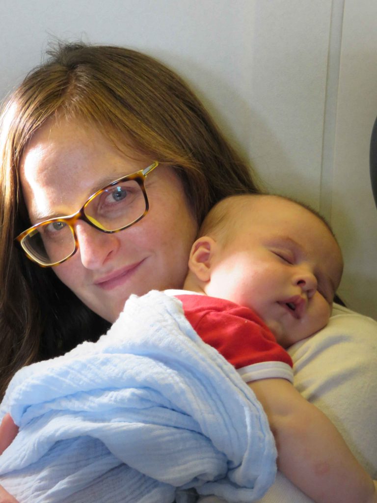 Celine Brewer, of BabyCanTravel.com, enjoys a flight with her a sleeping infant.