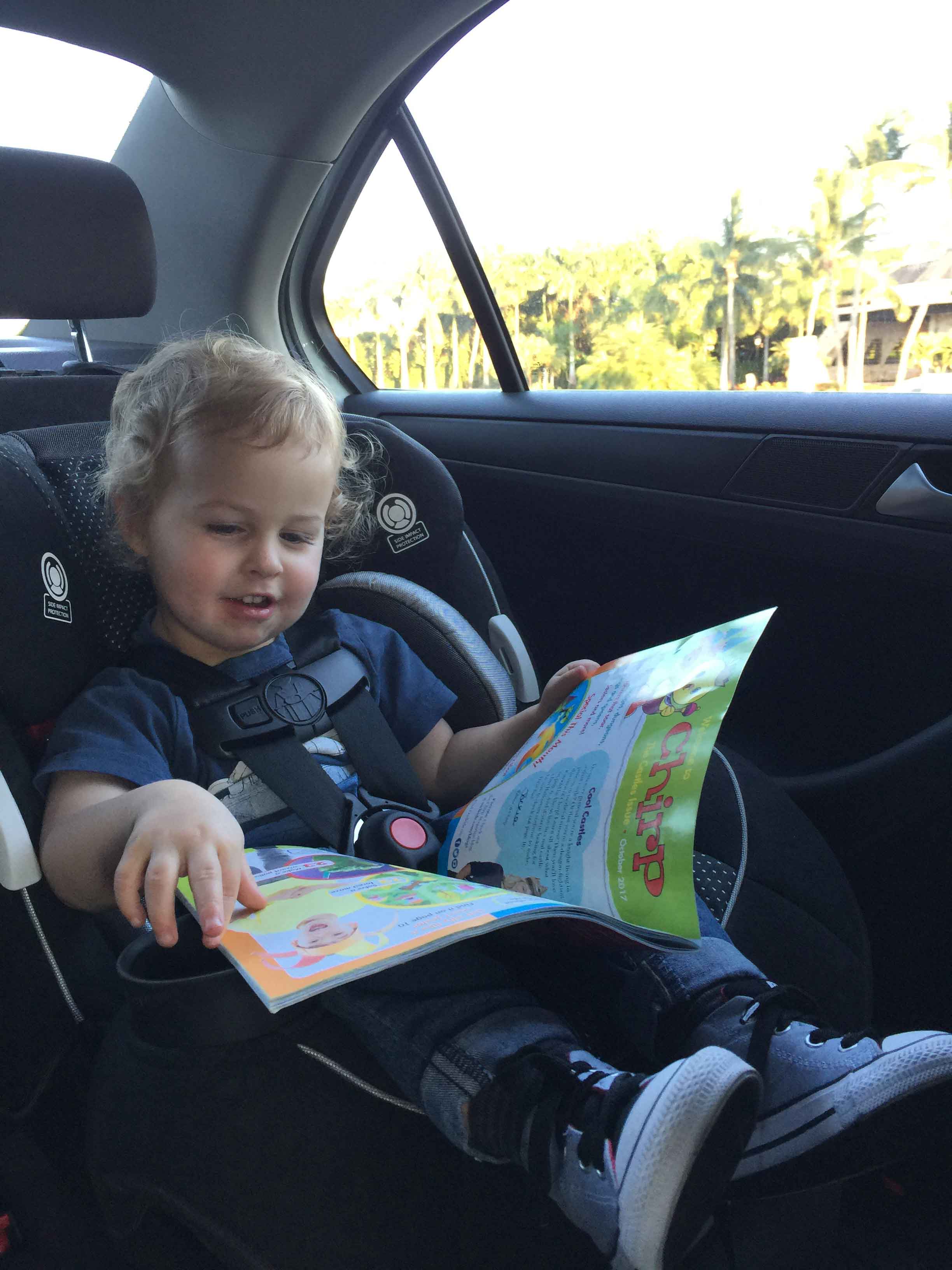 Toddler in car in car seat rental.