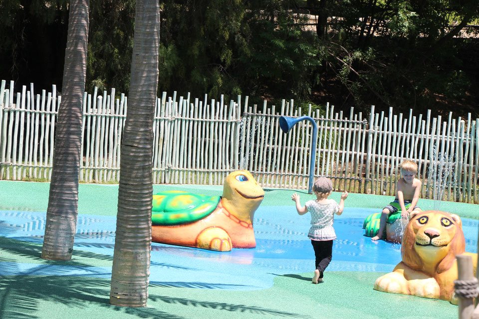 A toddler plays in the Savanna Cool Zone splash park at the San Diego Zoo Safari Park.