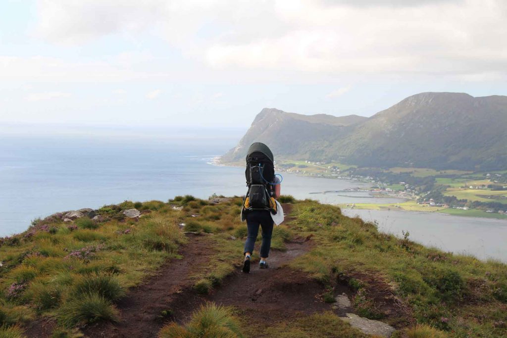 A mom enjoys a hike with her child in a Deuter Kid Comfort 3 - one of the best hiking backpacks for carrying toddlers.