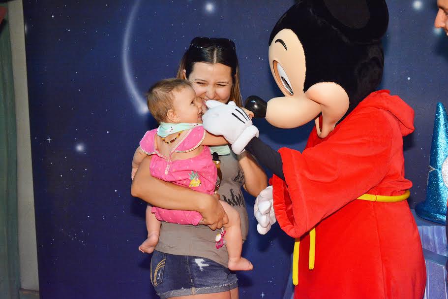 Character greetings at Disneyland with a baby