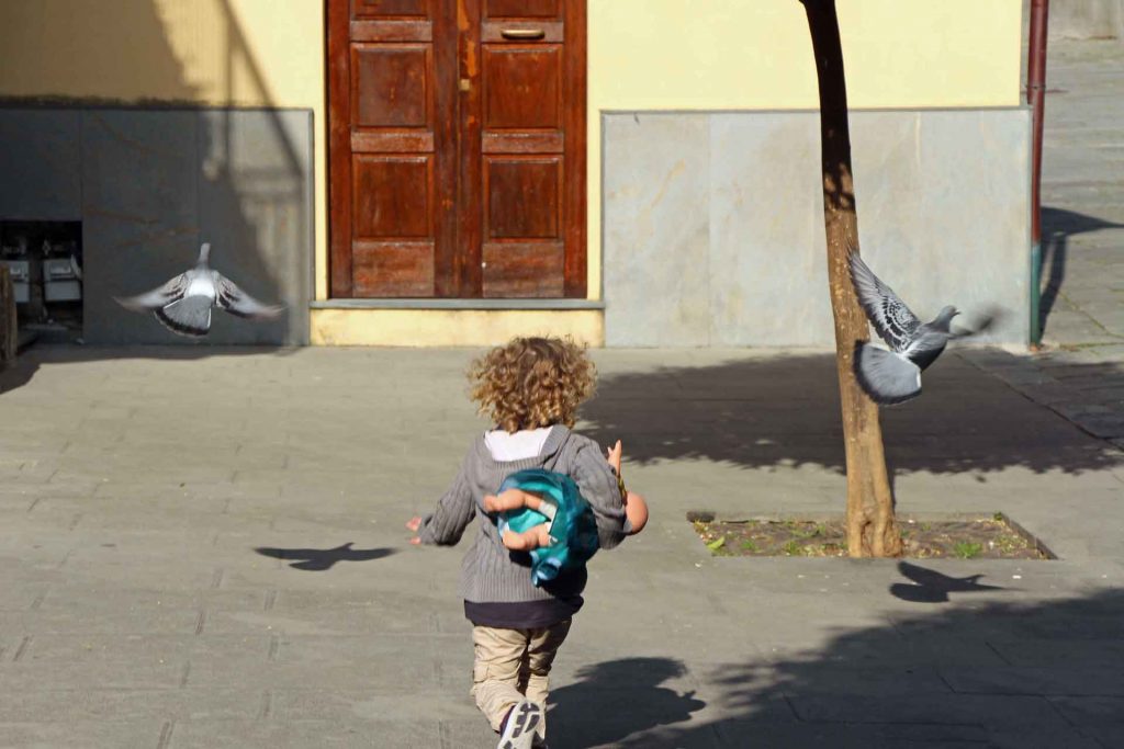 Visiting Italy with kids ultimately means watching them chase pigeons all day long toddler