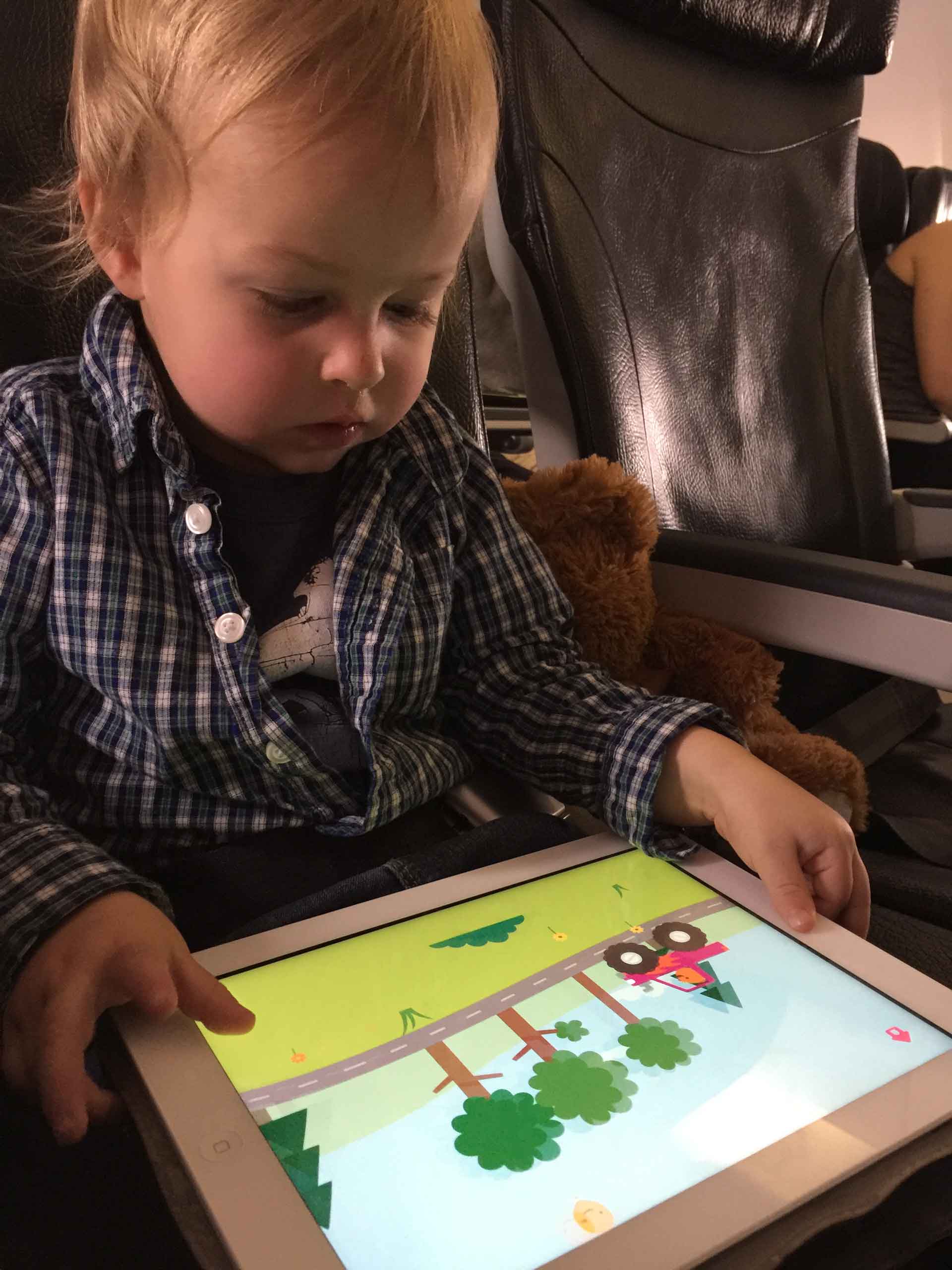 a toddler playing a simple iPad game on an iPad.