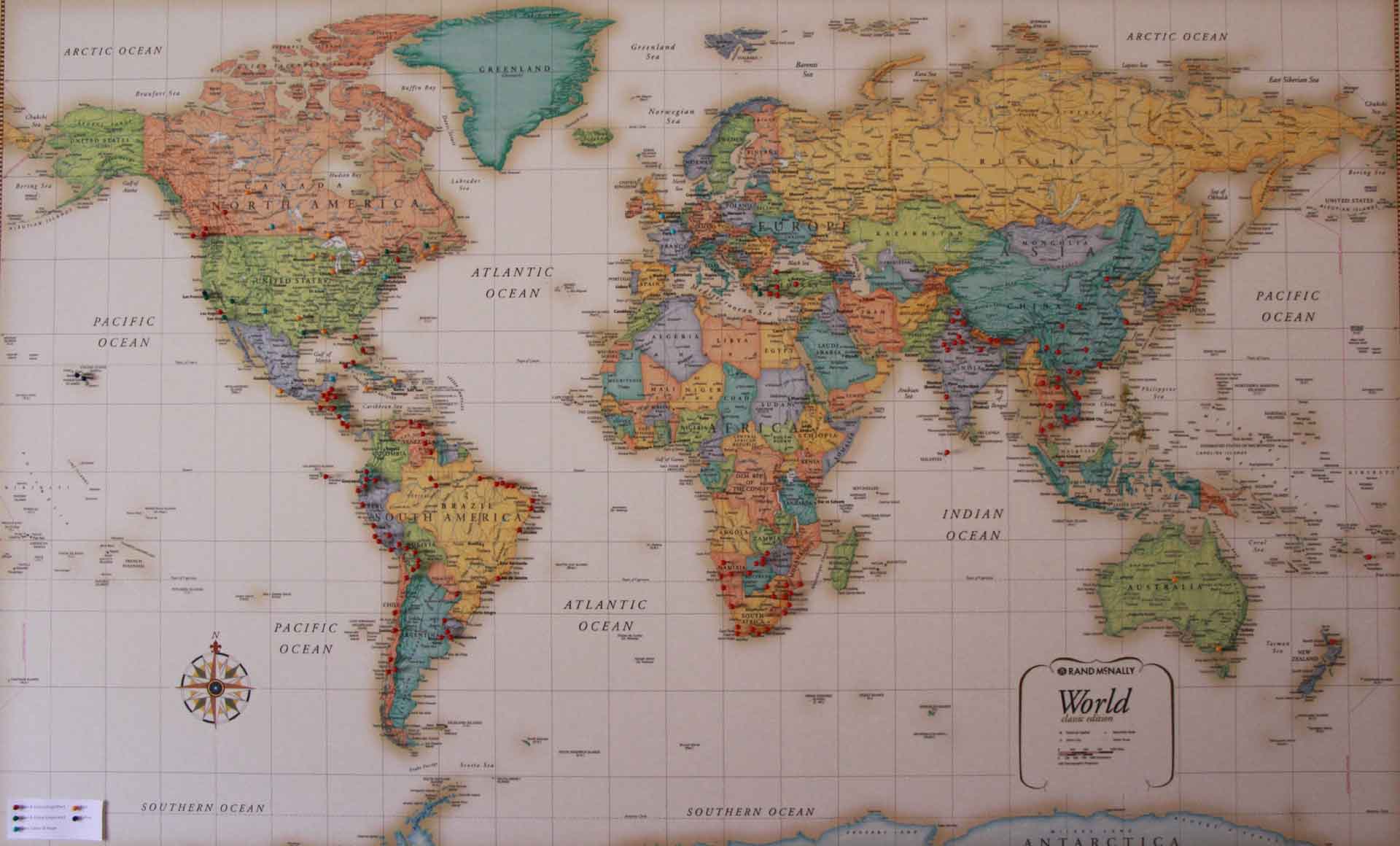 having a world map with pins on it is a fun way to raise children who love to travel.