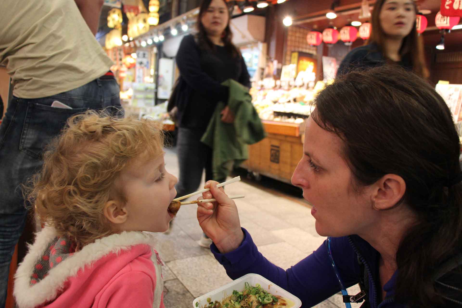 eating Takoyaki (octopus balls) at the  Nishiki Market in Kyoto Japan