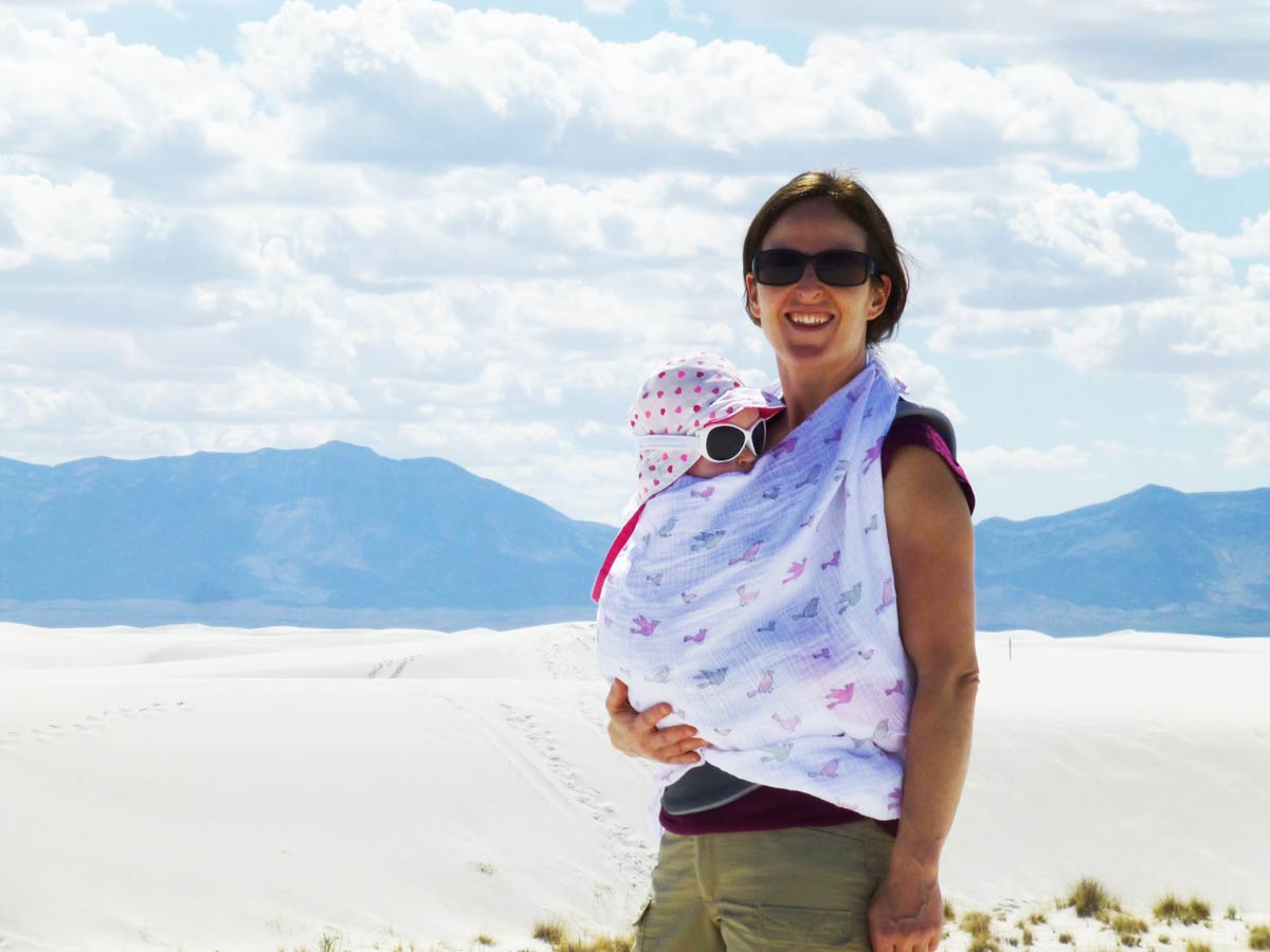 Baby Can Travel owner, Celine Brewer, protects her baby from the sun at the White Sands National Park using a swaddle blanket.