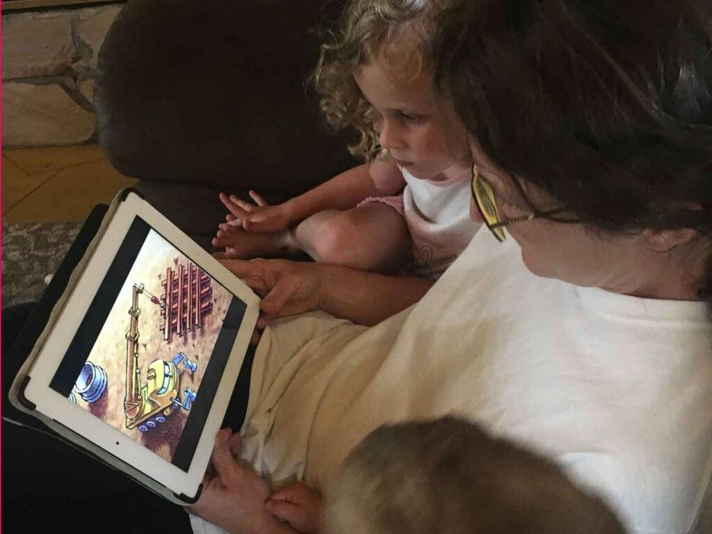 Celine Brewer, of BabyCanTravel.com, reads a bedtime story to her kids using a digital reading reading app.