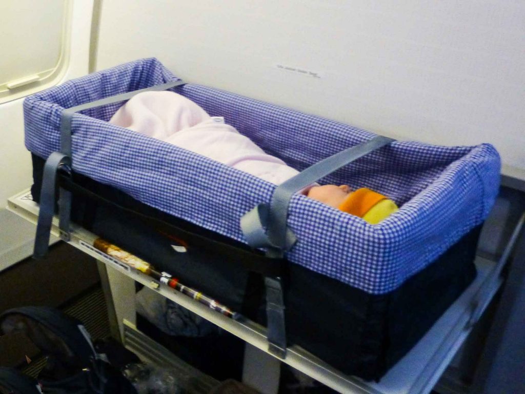 Celine Brewer's daughter sleeps in a bassinet on her very first flight.