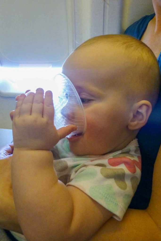 The plastic airline cups make great entertainment when flying with a baby