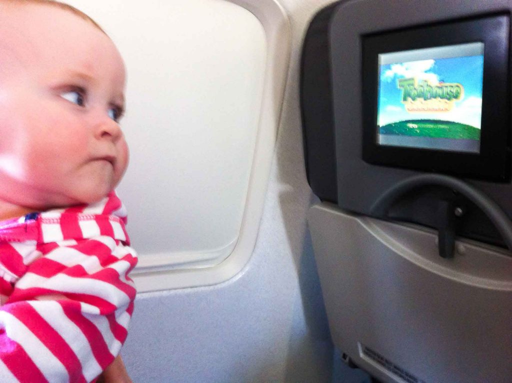 Another great way to entertain a baby on an airplane is to let them watch cartoons on the seat back entertainment system