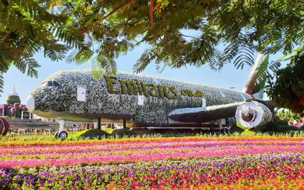 a flower covered Emirates airplane in Dubai
