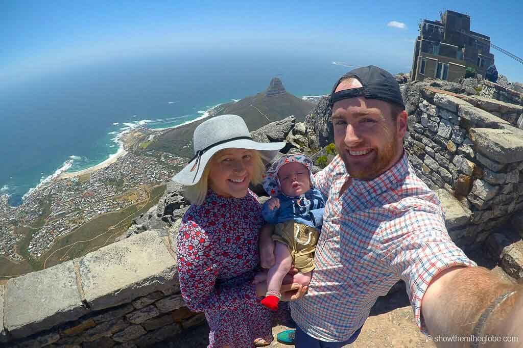 a family at the top of Table Mountain while visiting South Africa with a Baby