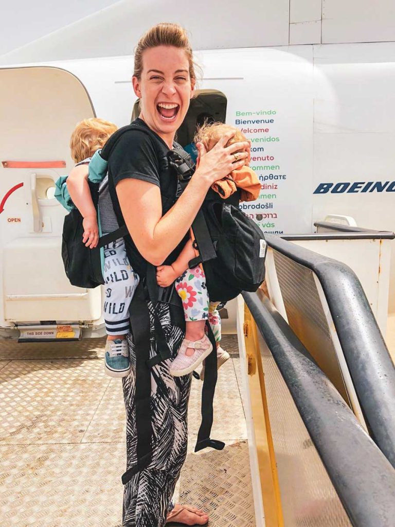 mom using twin baby carrier for travel