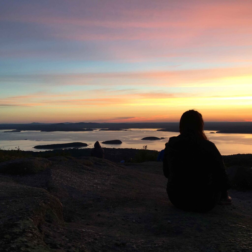 watching the sunrise on Cadillac Mountain while visiting Acadia National Park with a baby