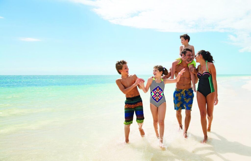 A family having fun in the Caribbean Sea at the Nickelodeon Punta Cana all-inclusive resort