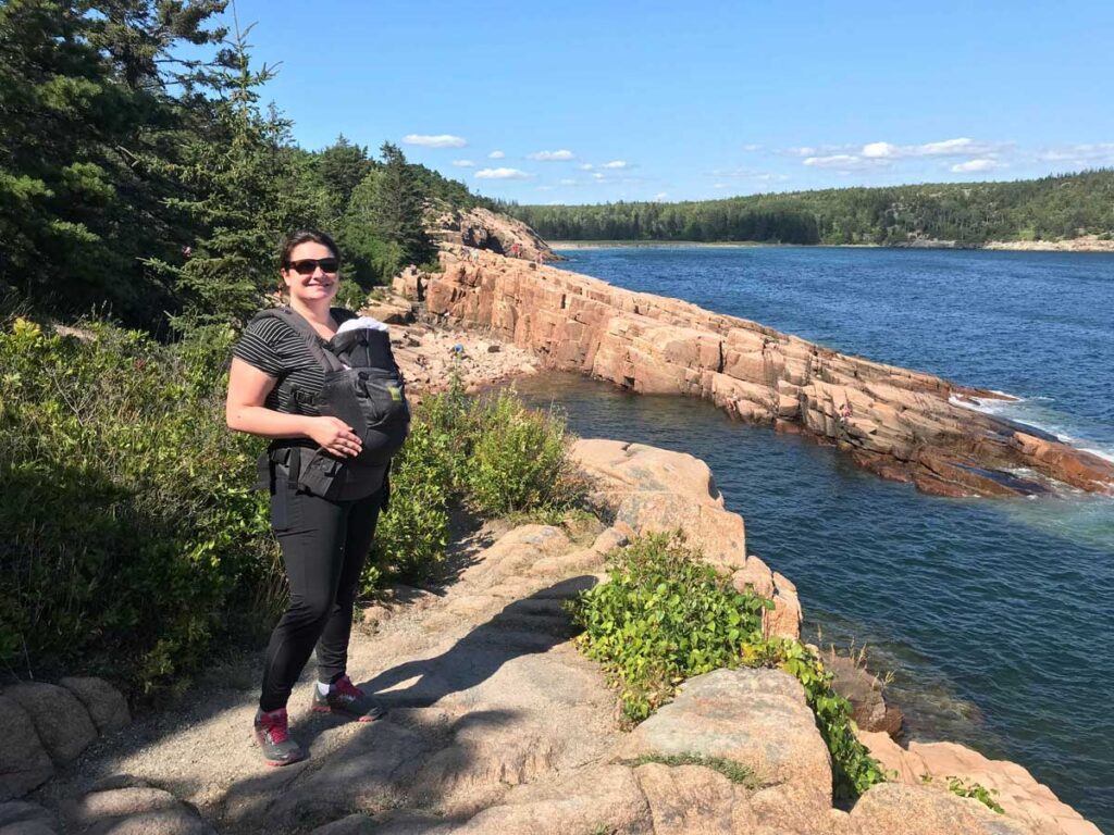 Hiking with baby in carrier in on the easy Ocean Path trail in Acadia National Park