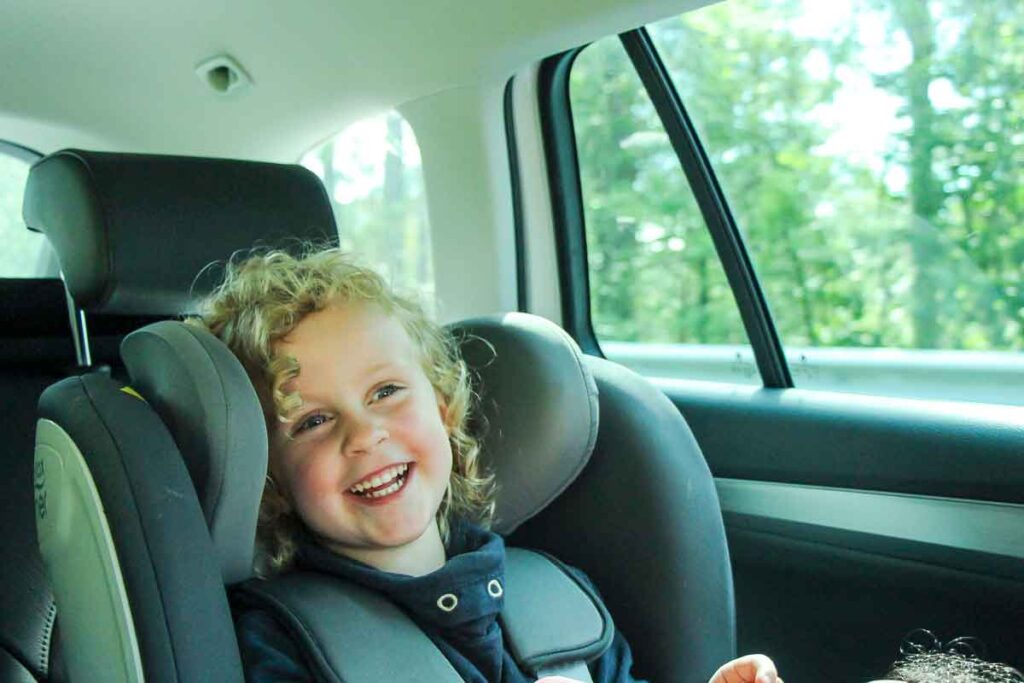 a happy child in a rented car seat 