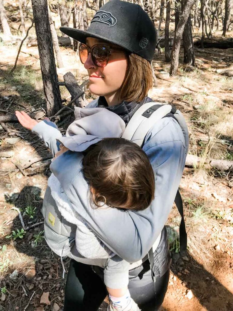 a mom has fun learning how to camp with a baby in the forest
