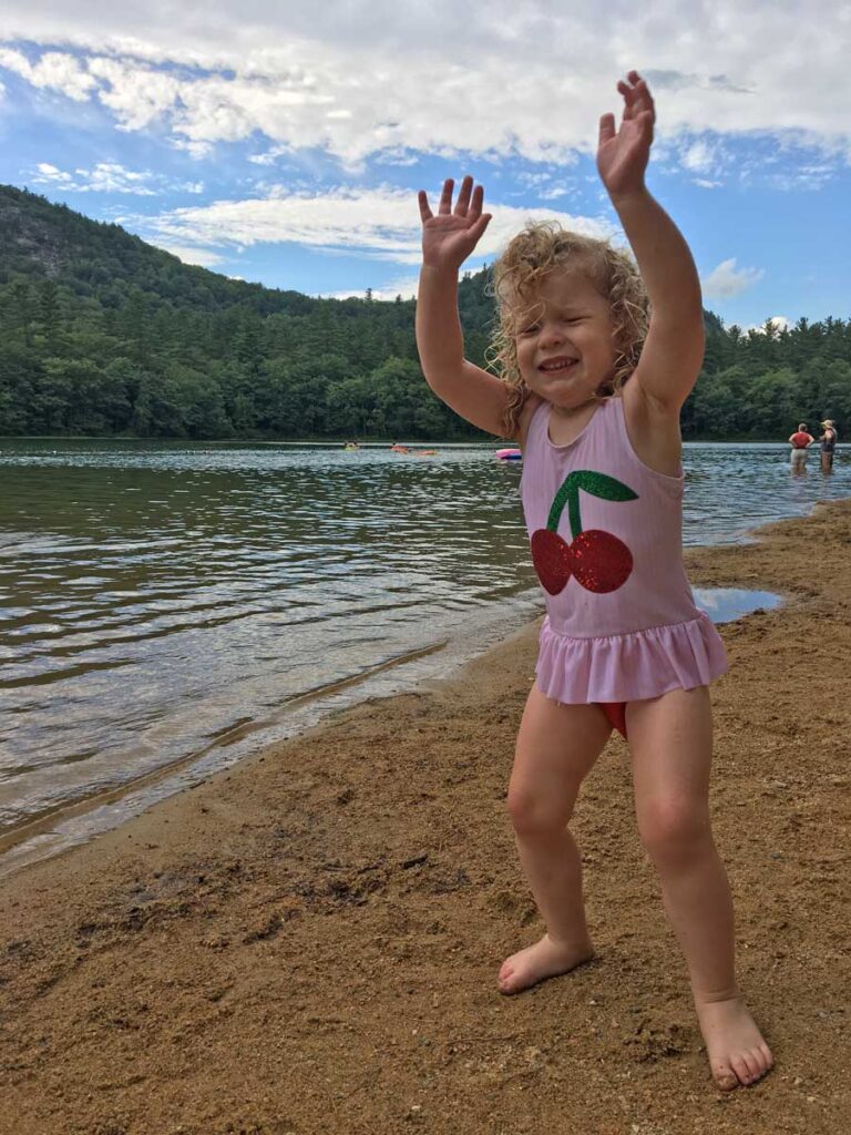 a toddler having fun on the beach at Echo Lake North Conway NH