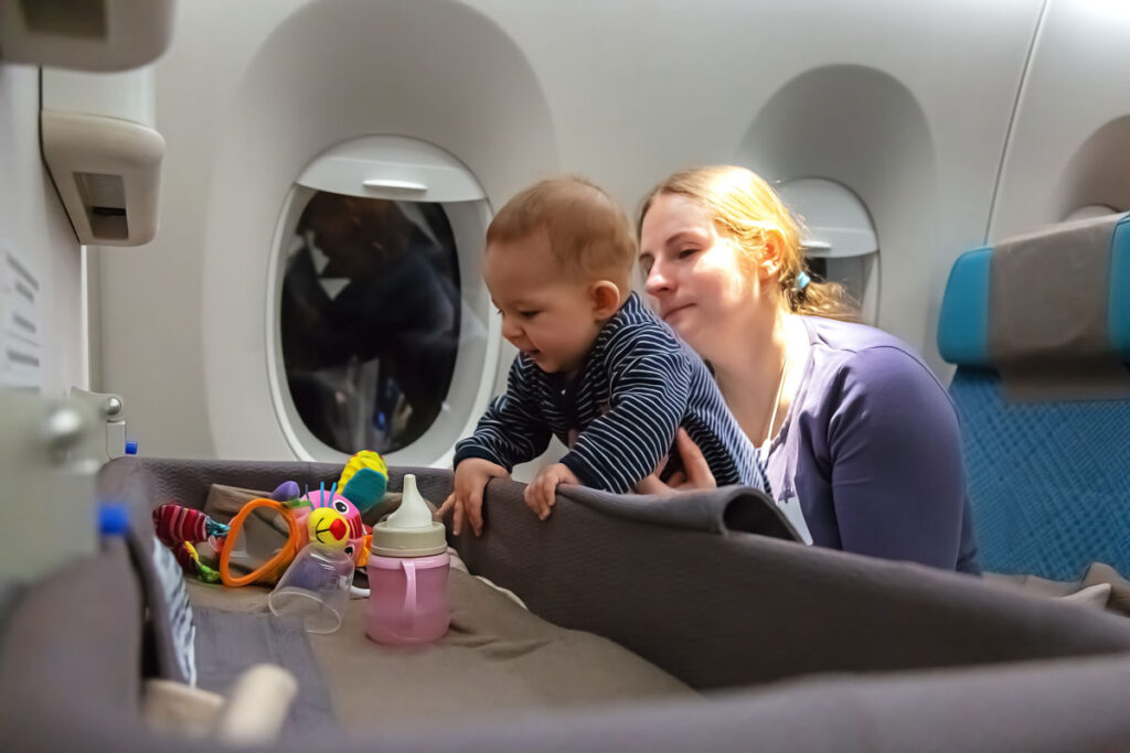 mother entertaining baby on flight