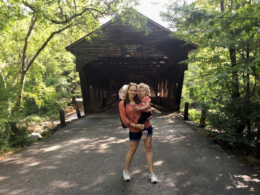 mom and toddler in front of Albany Covered Bridge on a family vacation to North Conway, NH