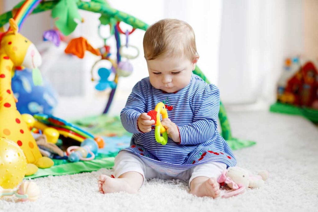 image of baby playing with toys