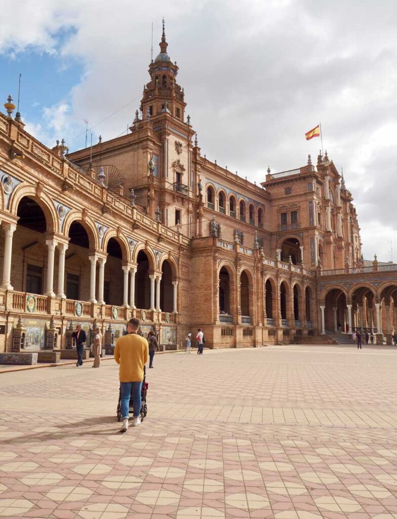 man walking stroller in Seville with a Baby