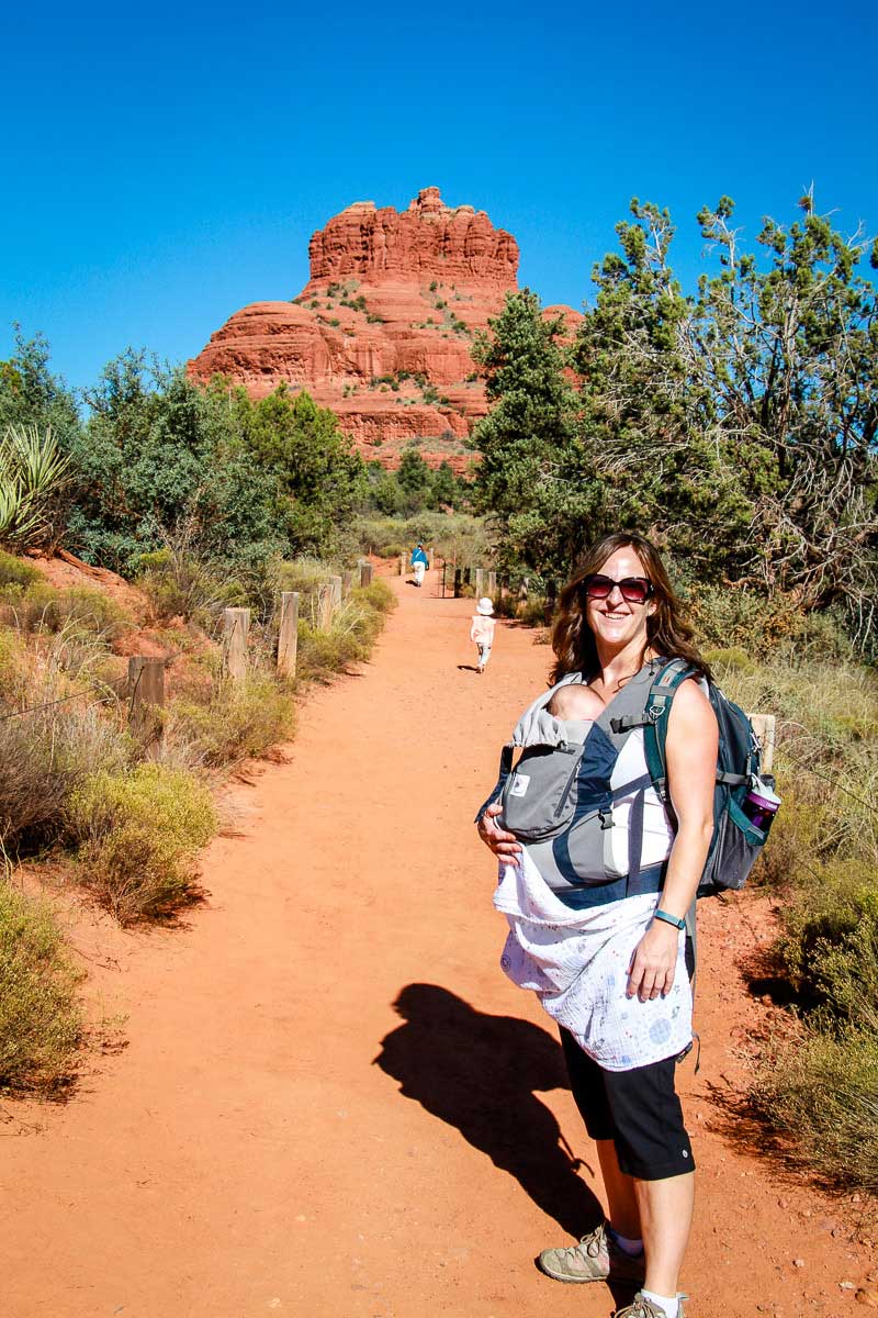 Celine Brewer, owner of Baby Can Travel, is hiking with her baby in Sedona, Arizona. She carries her baby in an Ergobaby carrier for hiking.