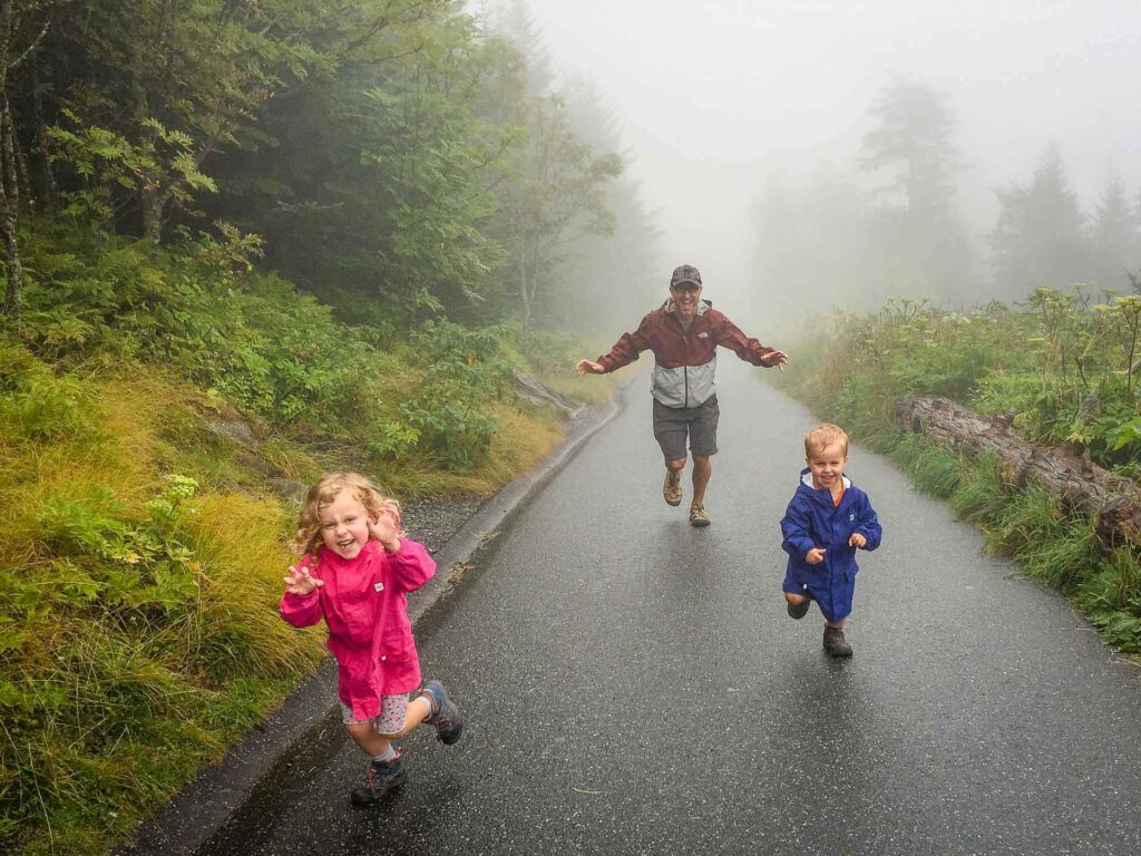 a father chases his toddler and preschooler in the fog at Clingmans Dome in Great Smoky Mountains National Park