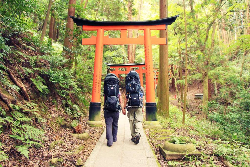 Dan Brewer and Celine Brewer, of the Baby Can Travel website, wear Deuter Kid Comfort 3 backpack carriers while hiking at the Fushimi Inari Shrine in Kyoto with their kids.