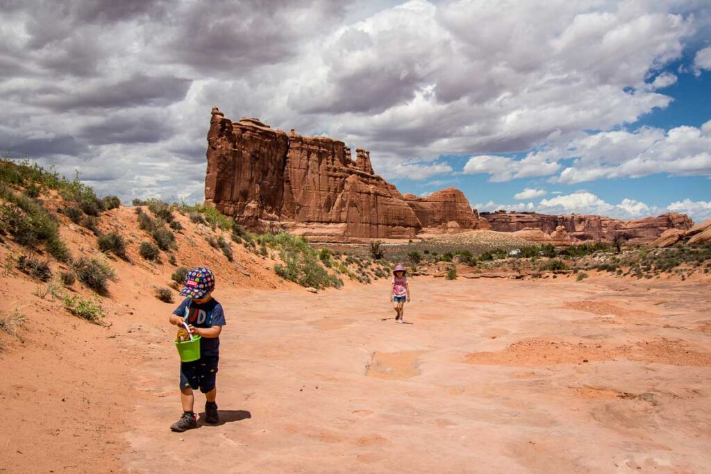 The Mighty 5 National Parks in Utah are home to some of the best toddler hikes in America. The Park Avenue Trail was one of our favorite hikes with a toddler in Arches National Park