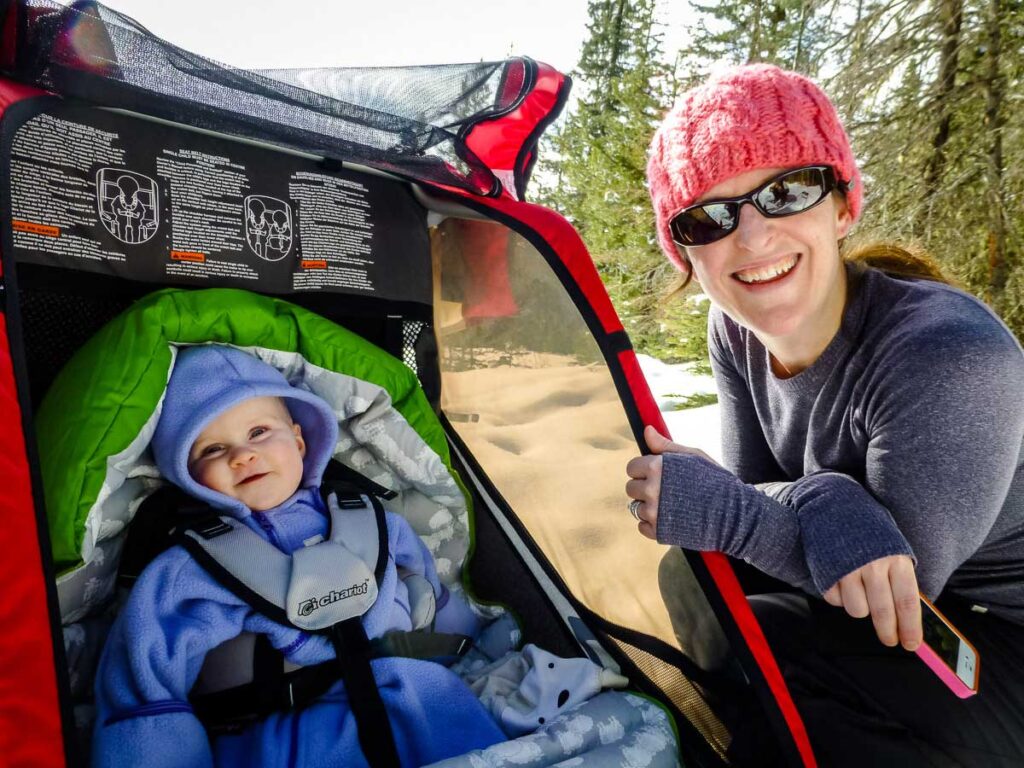 a mom goes hiking with baby in winter