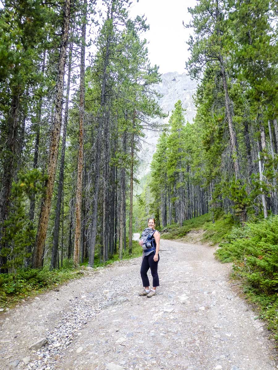 a proud mom hiking with newborn for the very first time on the Grassi Lakes trail in Kananaskis Country, Alberta, Canada