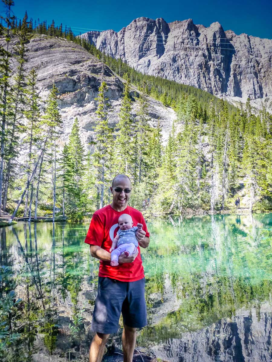 a proud dad is hiking with an infant