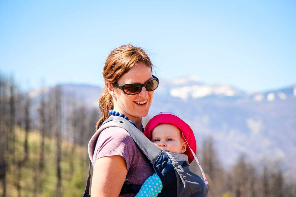 Celine Brewer, owner of BabyCanTravel.com, goes hiking with her baby in New Mexico. Her baby is in a front carrying Ergobaby carrier for hiking.