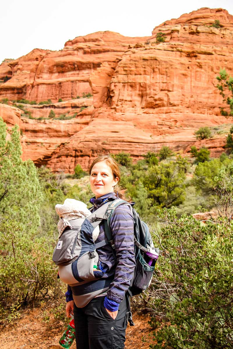 a mom hiking with a baby in sedona has her little one in a baby carrier for hiking