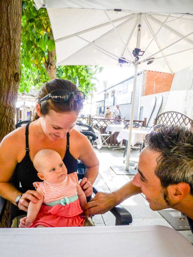 eating at a waterfront seafood restaurant in Barcelona with a baby