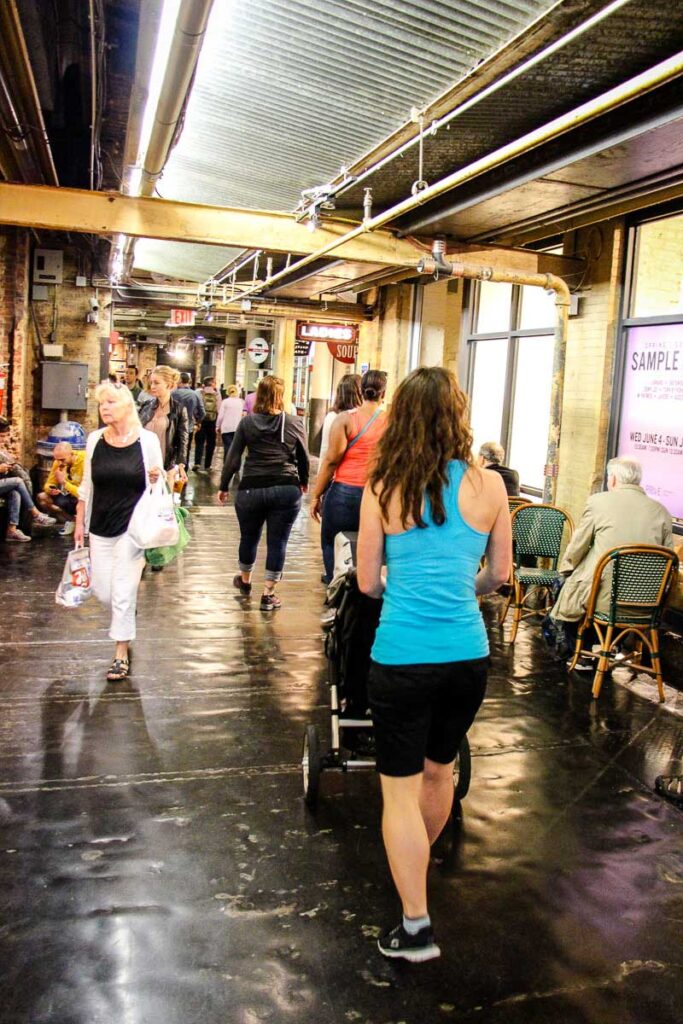 walking through Chelsea Market in New York with baby in stroller