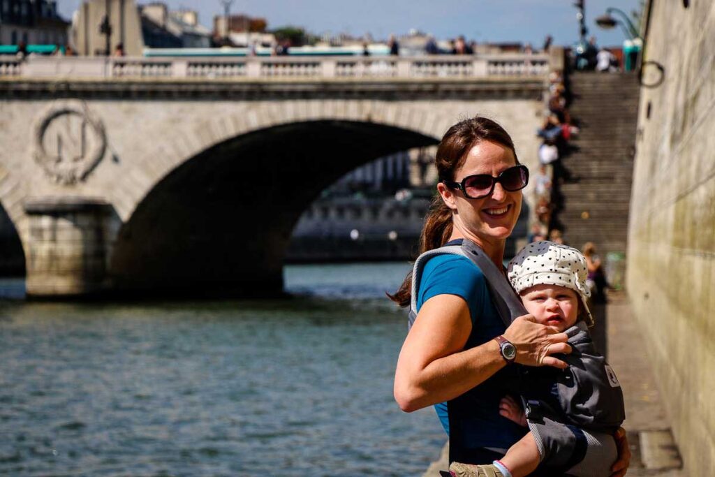 walking along la Seine in Paris with a Toddler in a carrier