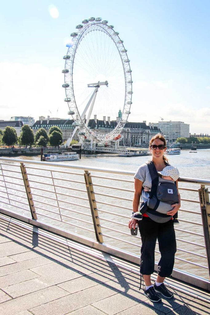 standing in front of the London Eye with a baby in baby carrier