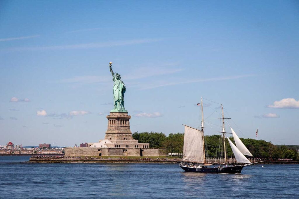 view of statue of liberty from staten island ferry in nyc with baby