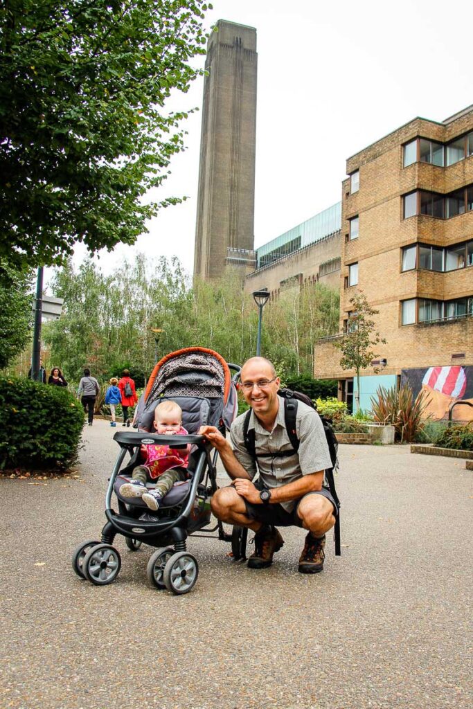 standing in front of Tate Modern in London with a toddler